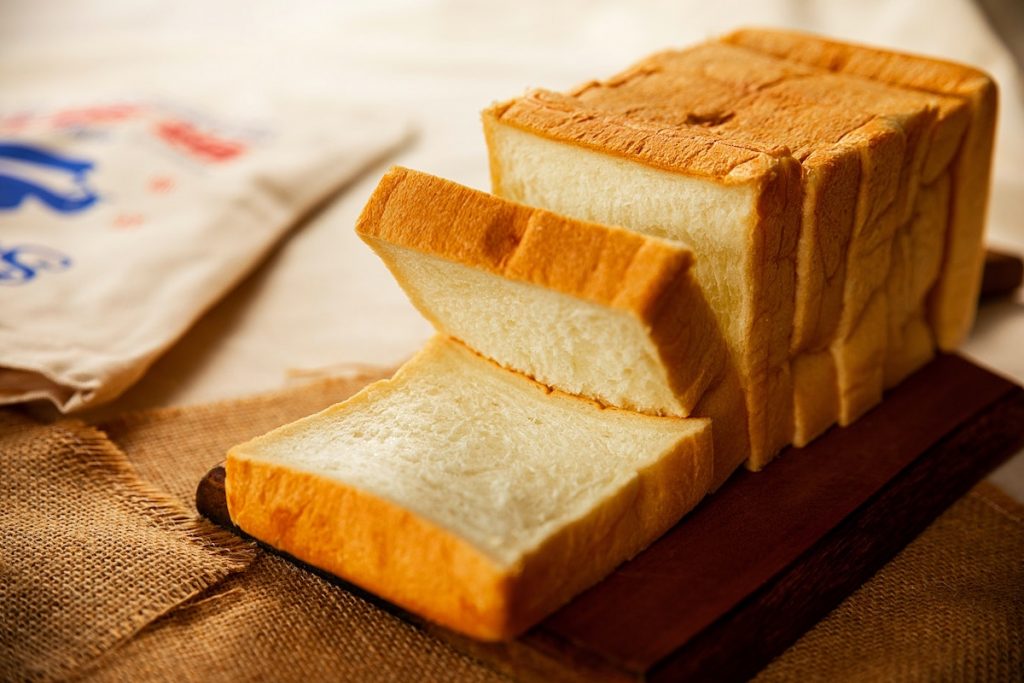 a sliced loaf of bread served on a table