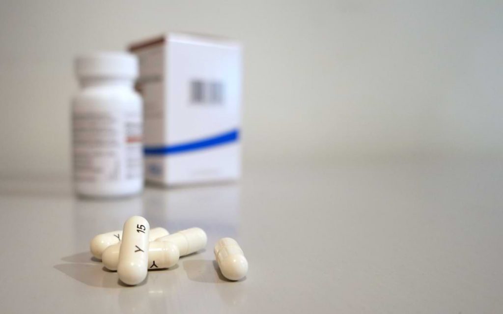 pills next to a pill bottle