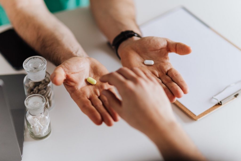 healthcare professional weighing up the choice of medications for a patient