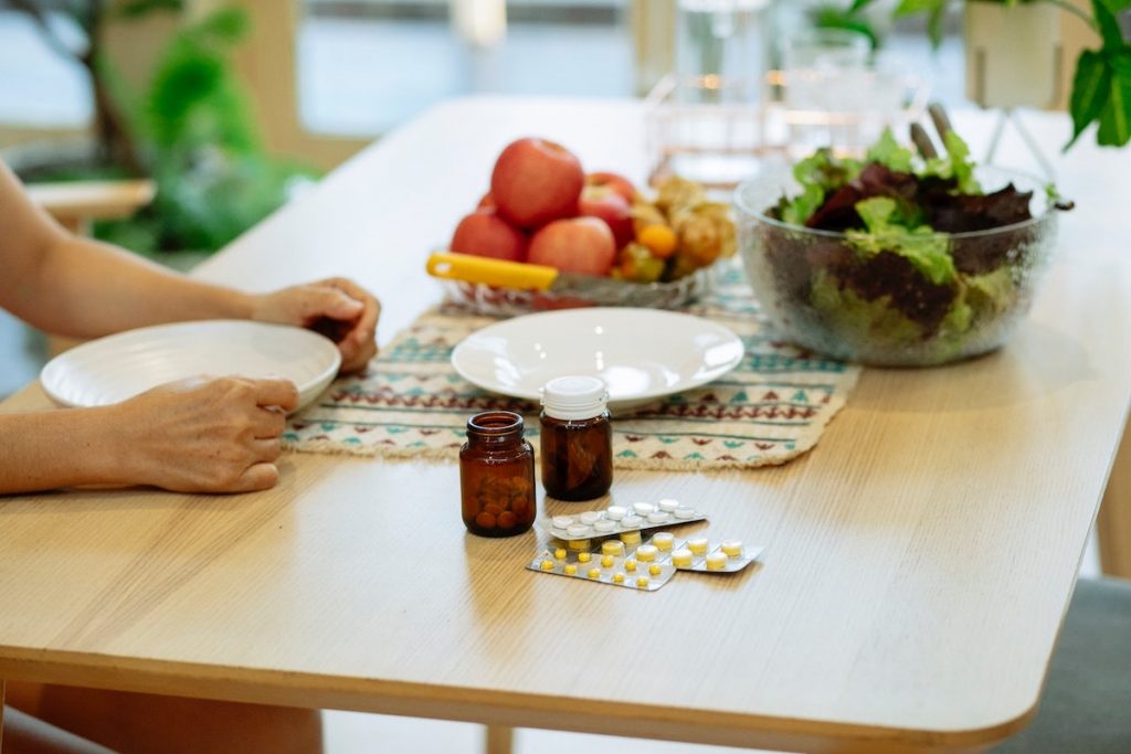 pills and food on a table - Can Dexilant be taken with food, yes, with a balanced approach