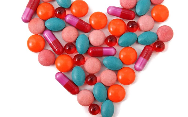 8592728 - heart from milticolor pills on white background