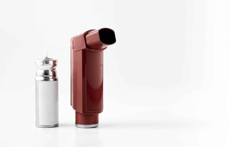 Brown MDI Inhaler. Asthma and Allergy aerosol for people with respiratory problems. White neutral background.