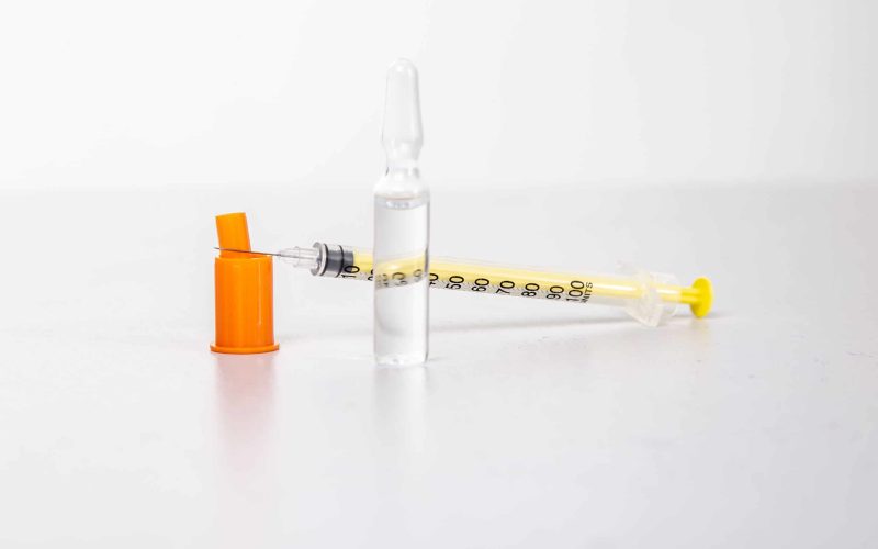 Insulin syringe with vial on a light table