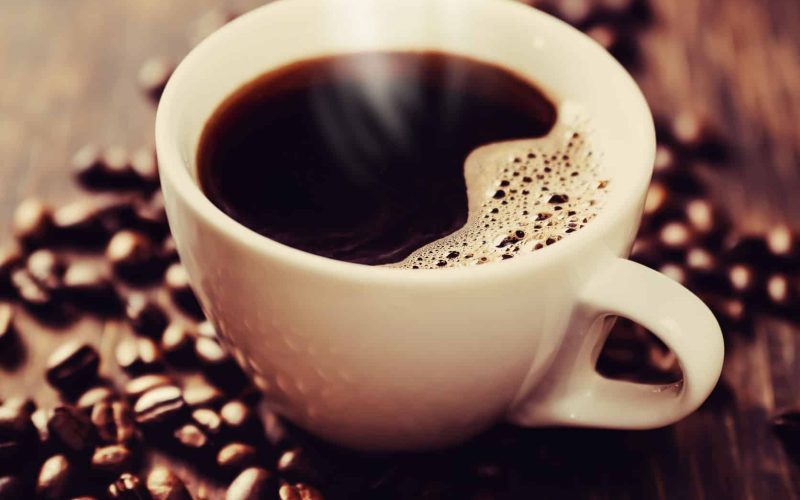 Steaming cup of freshly brewed coffee. Shallow depth of field