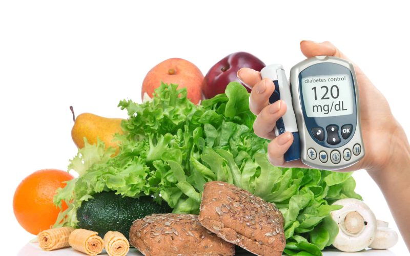 Diabetes diabetic concept. Measuring glucose level blood test on organic food fruits and vegetables background