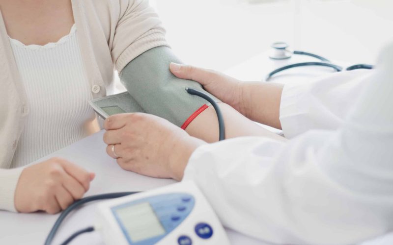 The doctor measures blood pressure to the patient