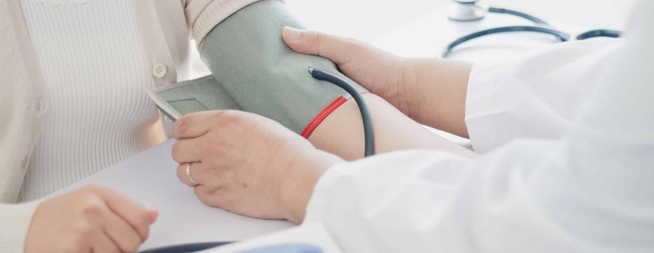 The doctor measures blood pressure to the patient